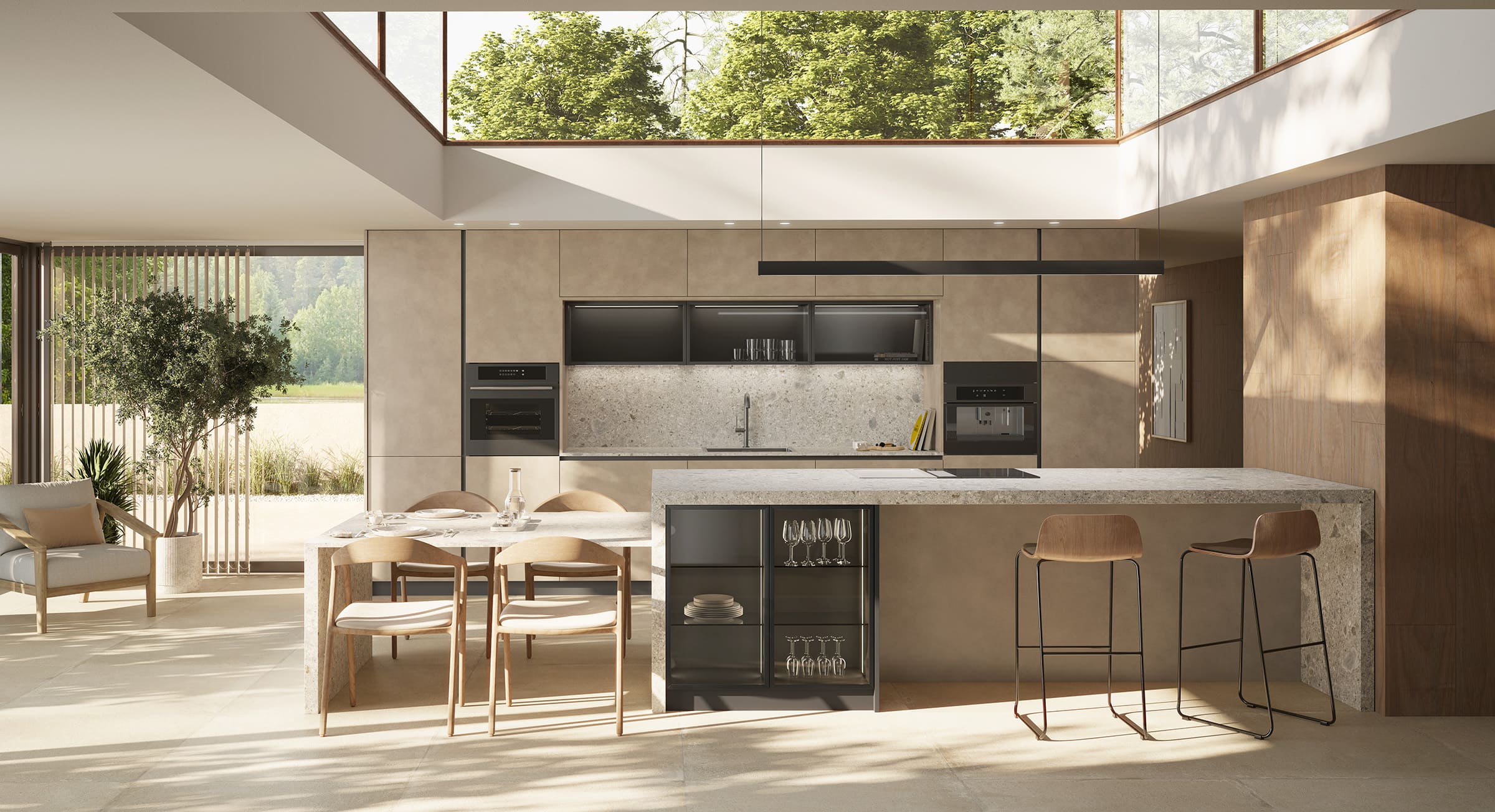 Cocina contemporánea con gran isla central, muebles en tonos piedra y barra con taburetes altos.